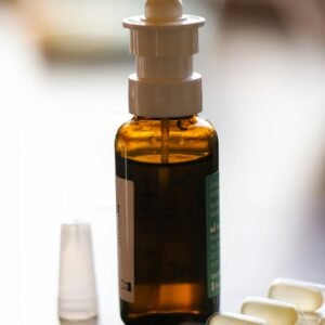 Close-up of a nasal spray bottle and capsules, ideal for healthcare use.